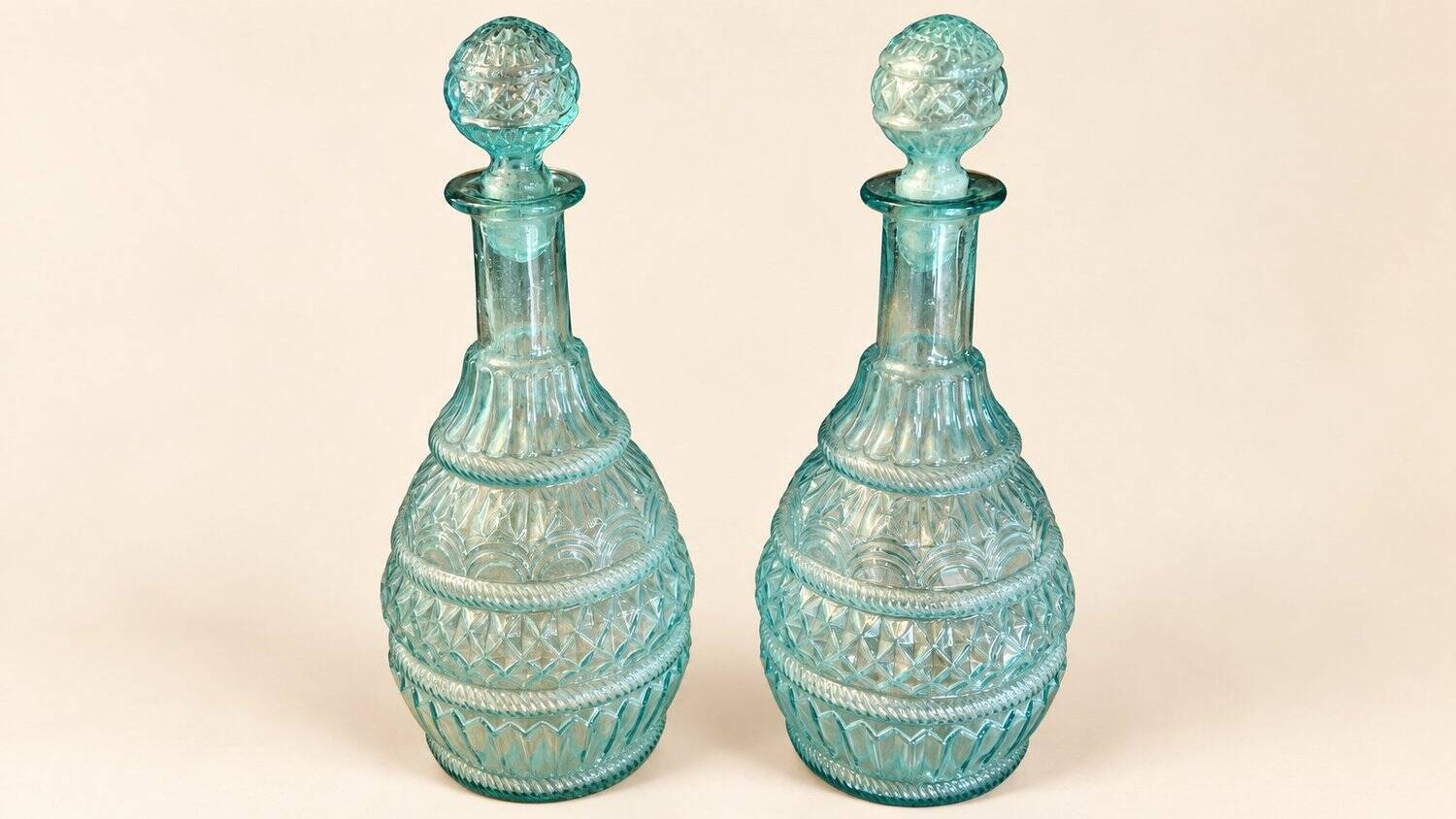 Pair of cut blown glass carafes in blue-green from the 19th century.