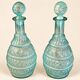 Pair of cut blown glass carafes in blue-green from the 19th century.