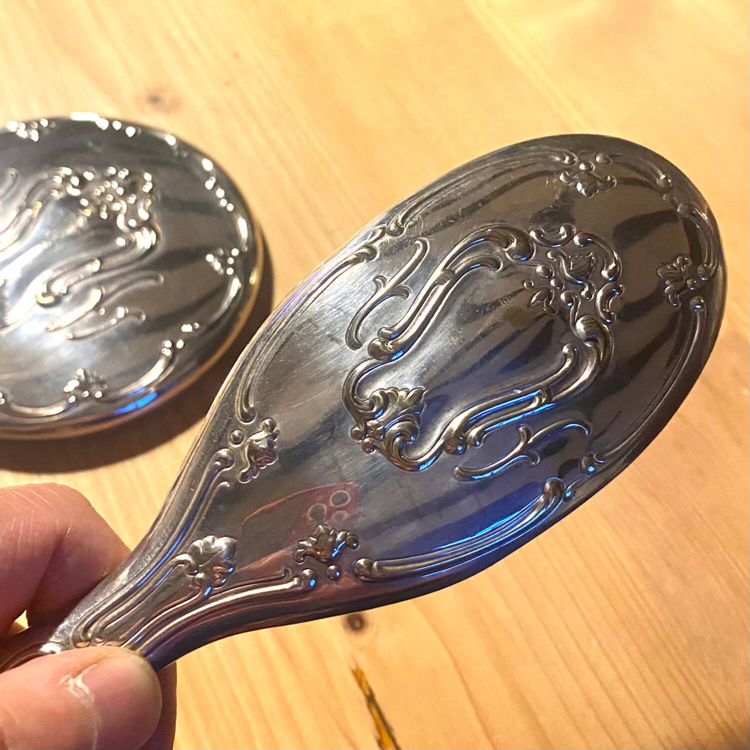 Silver metal hand mirror and laundry brush