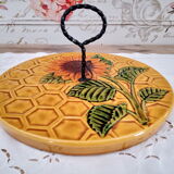 Vintage yellow earthenware cheese dish with sunflower decor and wrought iron handle