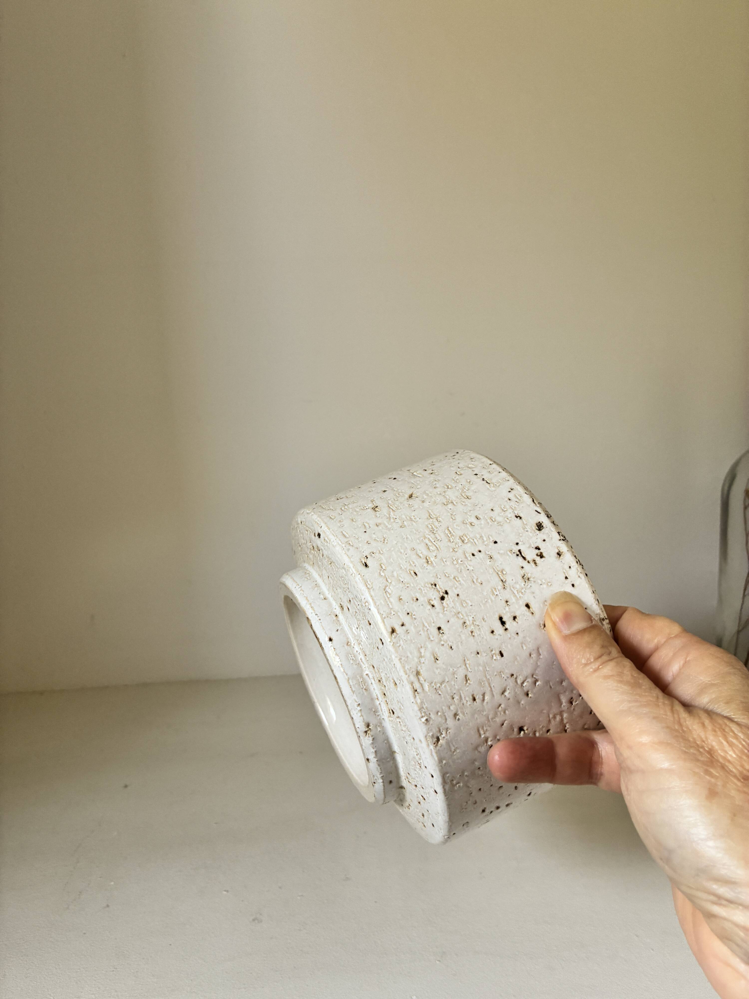 White ceramic vase with a textured effect.