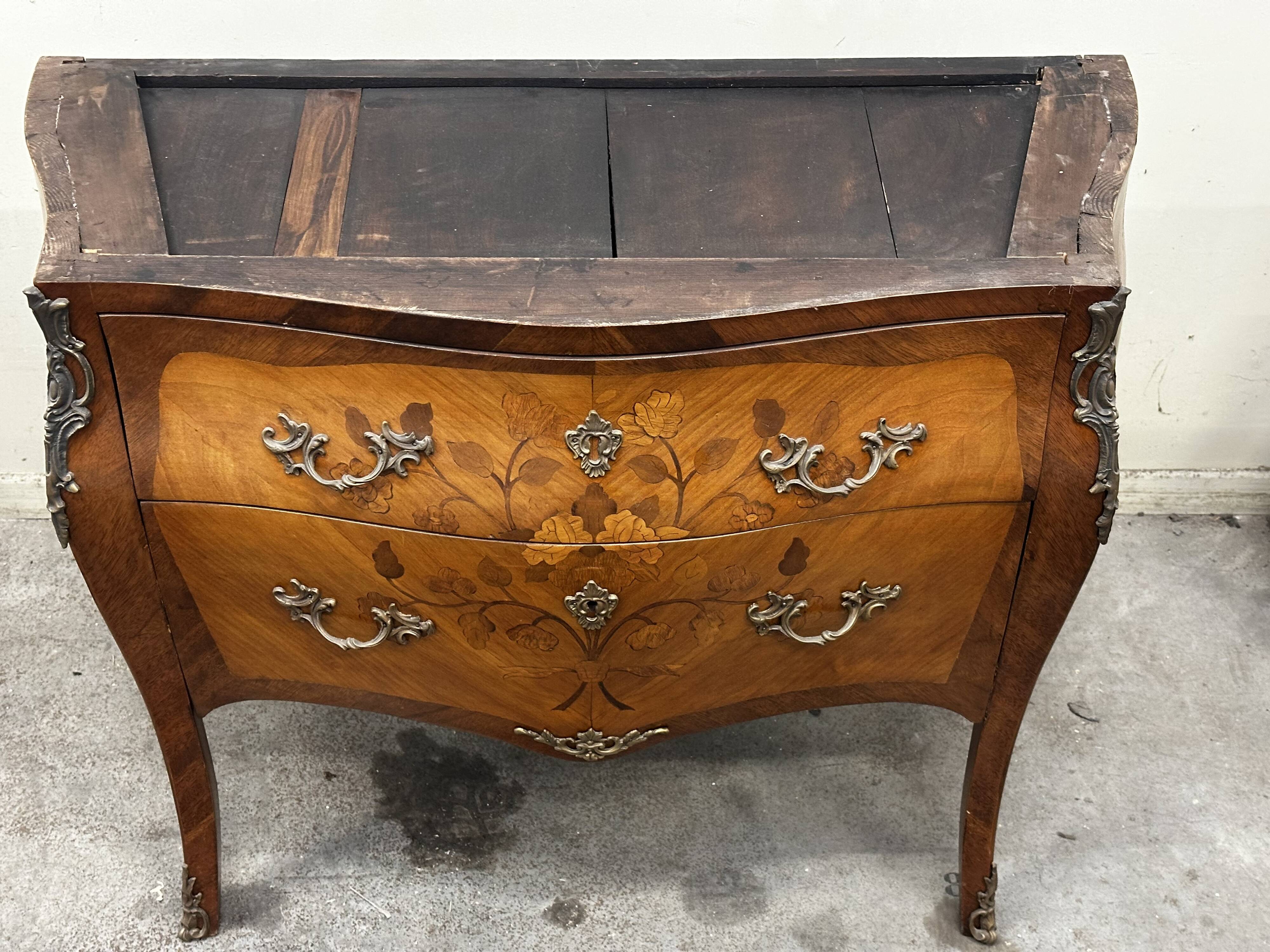 Curved and inlaid Louis XV style chest of drawers