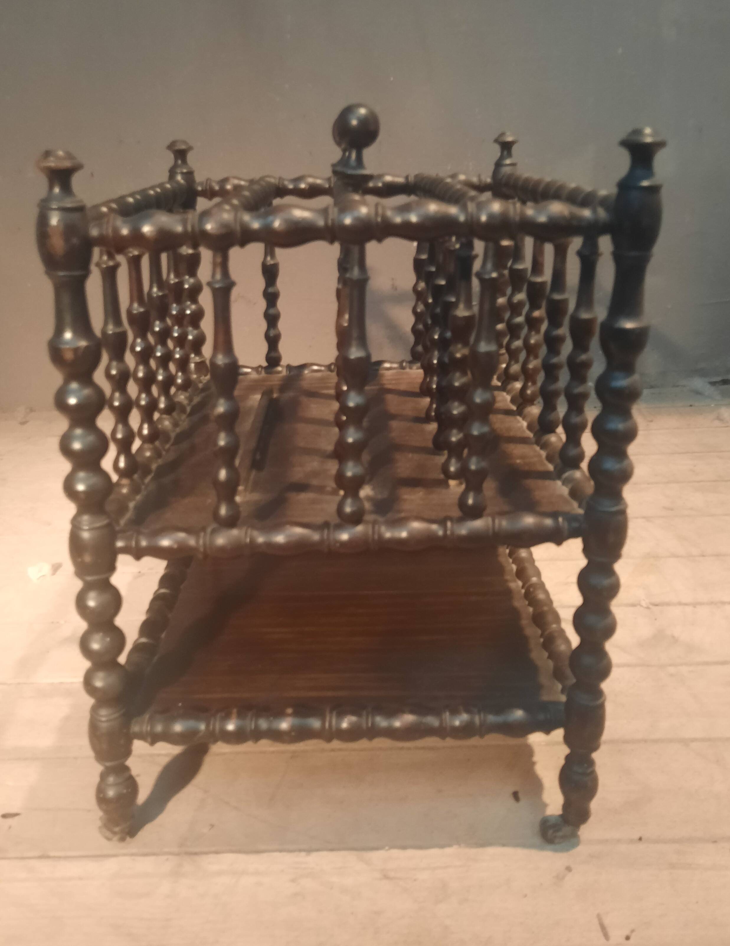 Rosewood magazine rack on casters