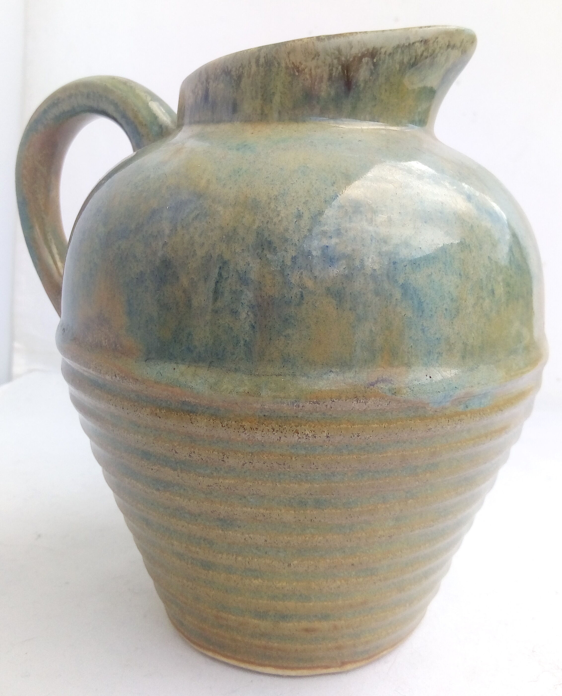 Blue enamelled sandstone pitcher and ochre streaks