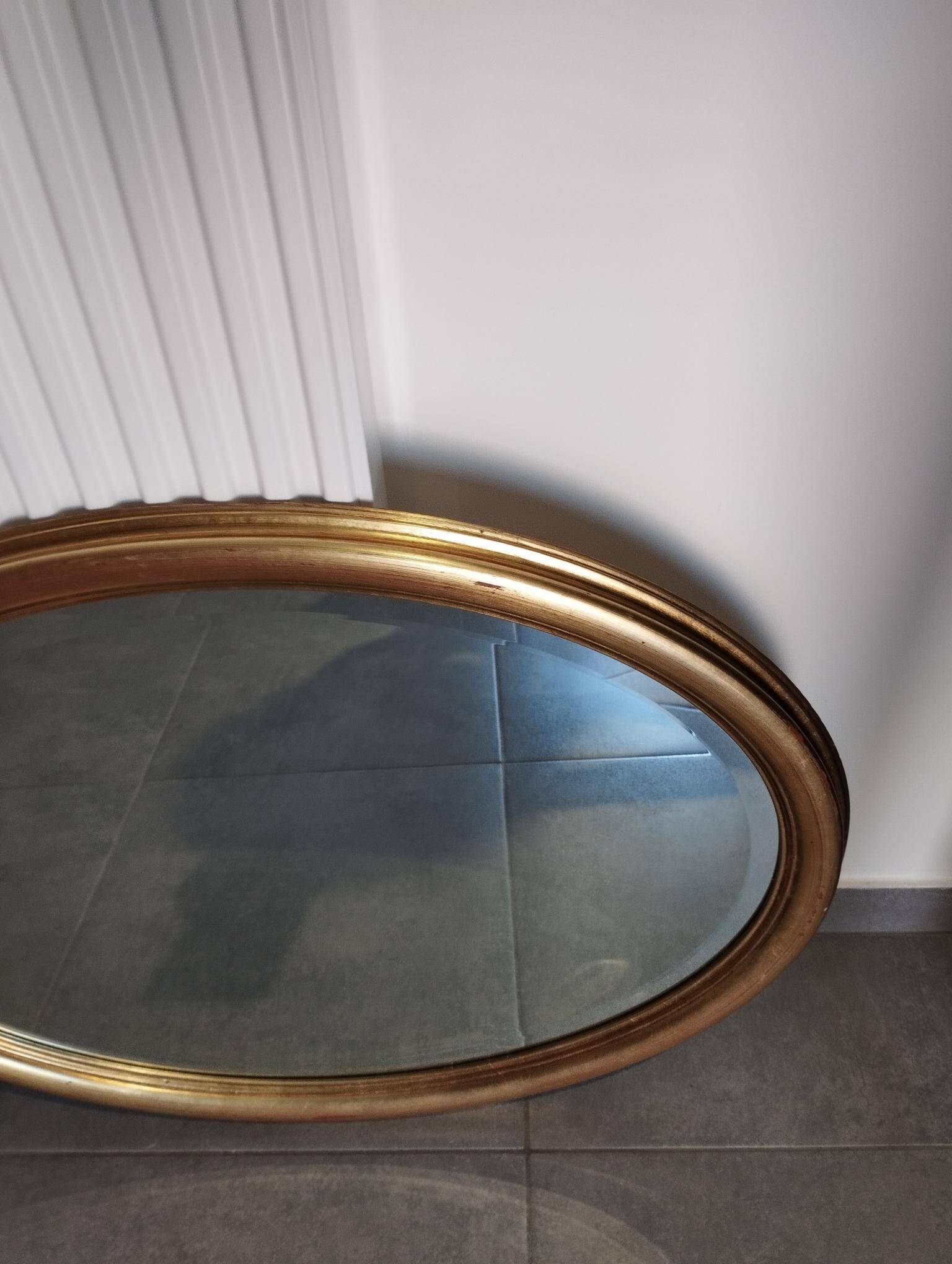 Grand et élégant miroir doré ovale avec sa glace biseauté