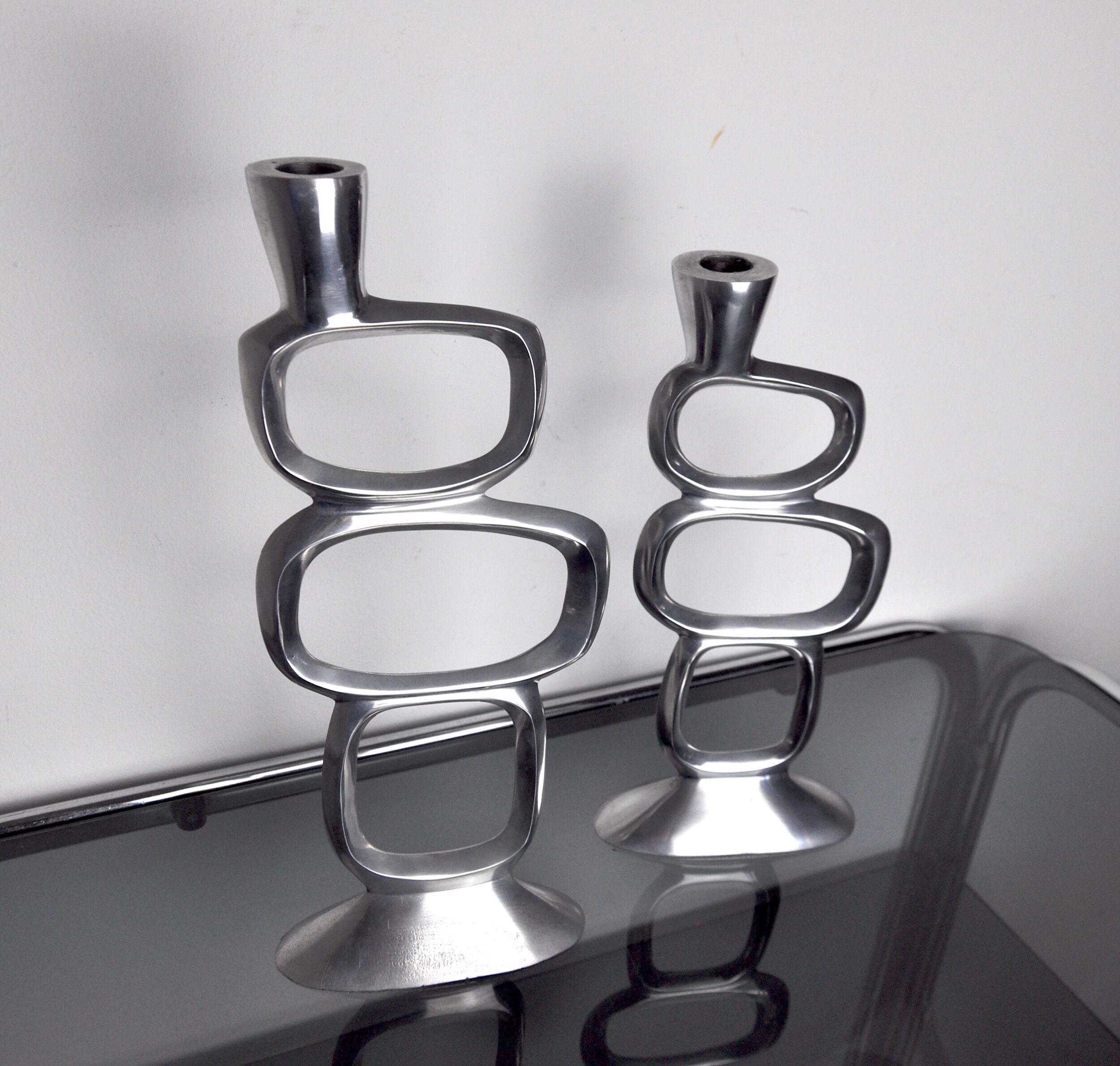 Pair of circle candlesticks by matthew hilton, england, 1980