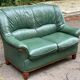 Vintage 2-seater sofa in green leather and solid wood