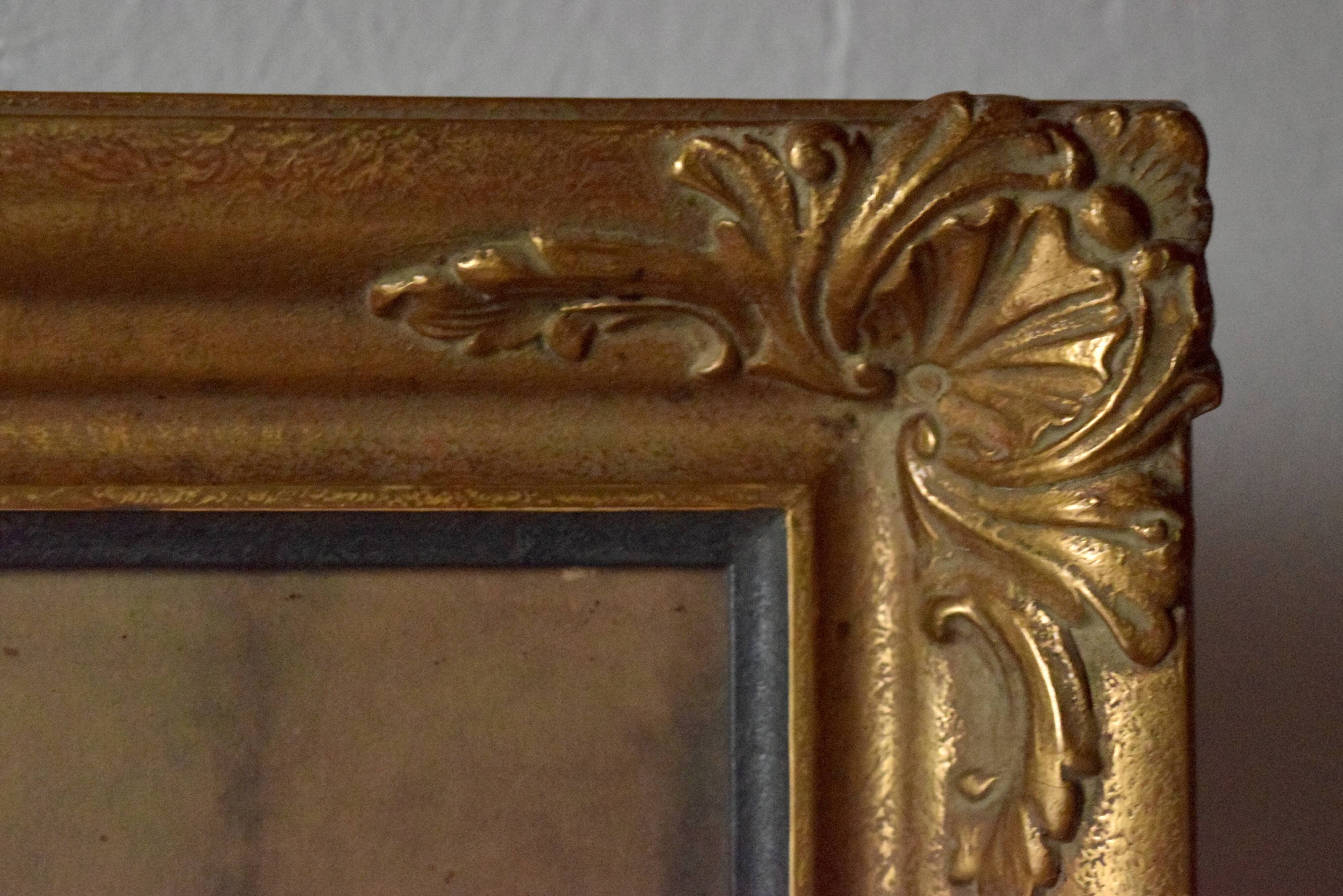 Old large wall frame in gilded carved wood