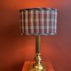Lamp base in gilded brass, oval silk lampshade with a checkered pattern in burgundy.