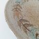 Speckled stoneware plate with floral decoration