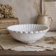Ancien plat creux en faïence blanche godronnée XIXeme