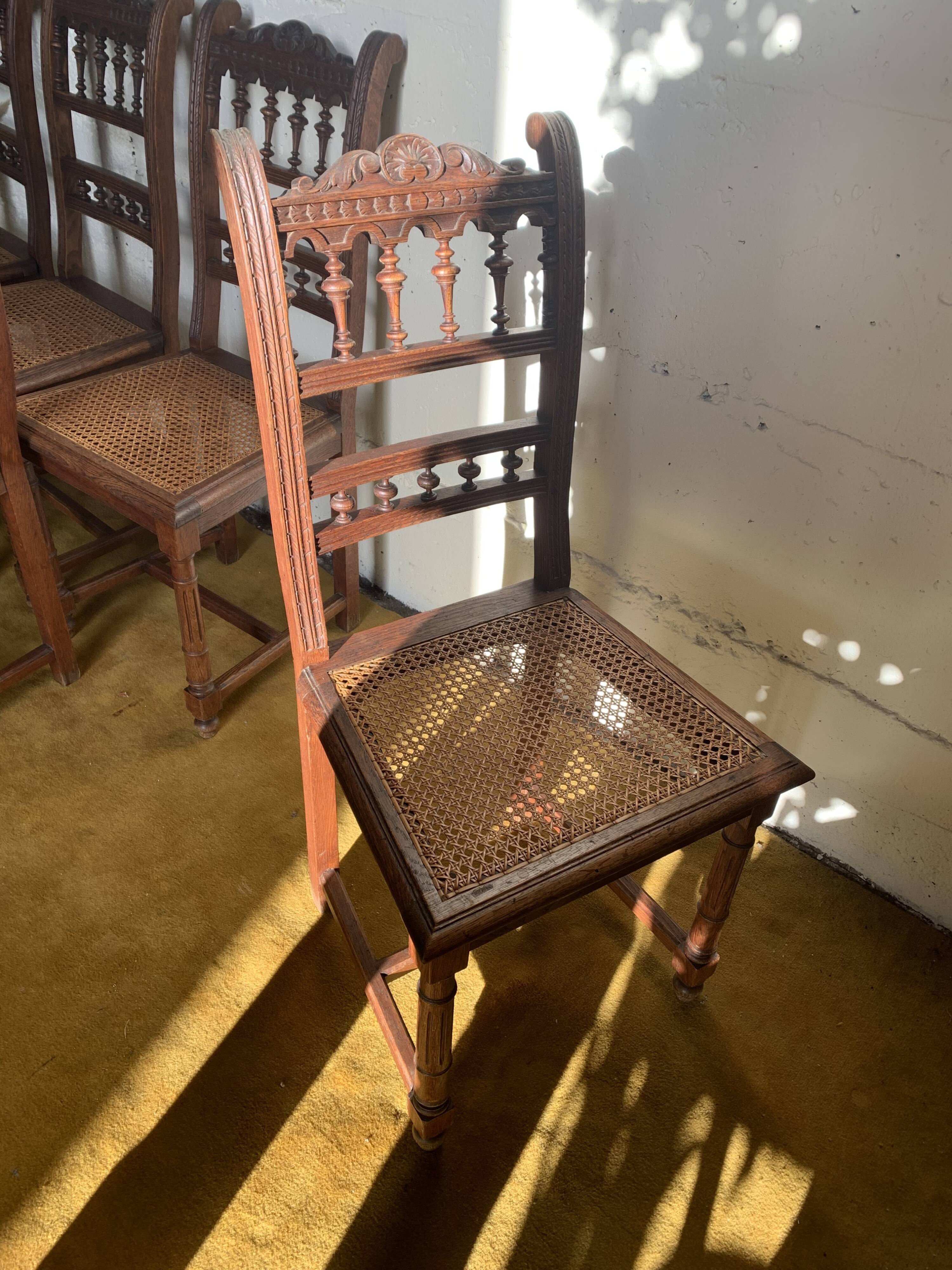 6 carved wooden chairs with cane seats
