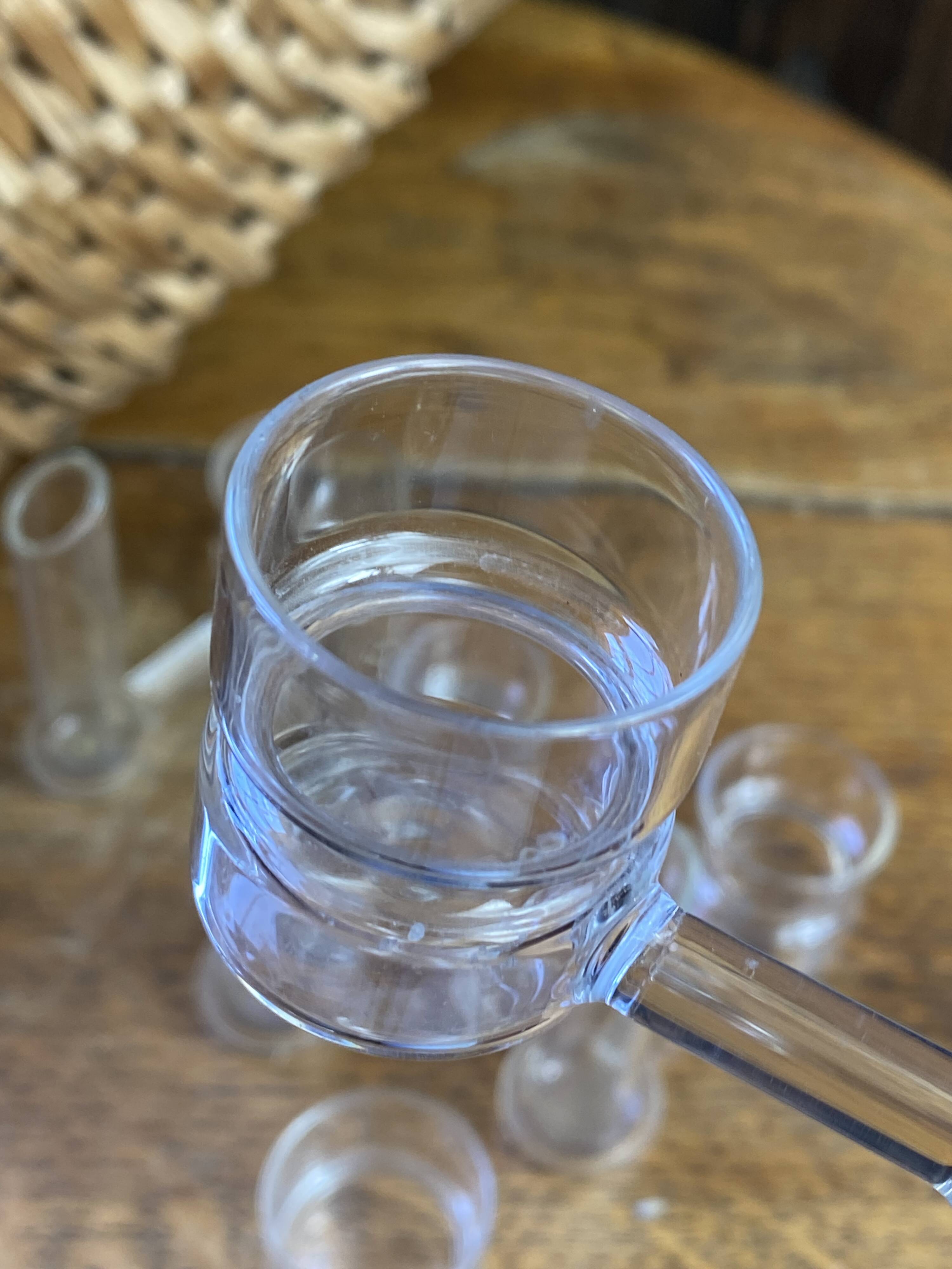 Knife rests, flower vases and candle holders in blown glass.