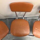 4 metal chairs and brown skai