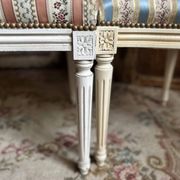 Pair of Louis XVI style chairs in painted wood and satin, classic elegance.