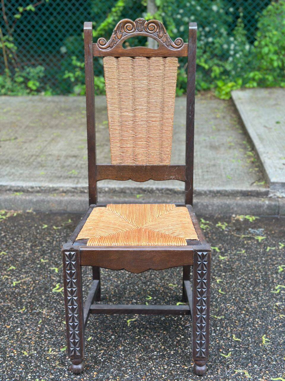 4 Basque solid wood dining chairs with carved straw seats.
