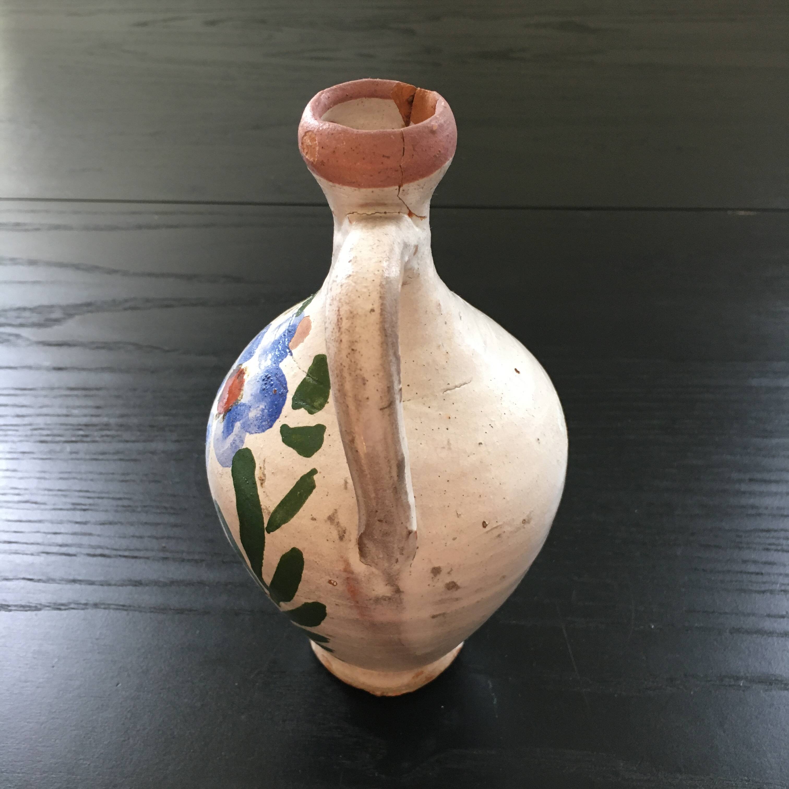 Small old amphora with floral decoration