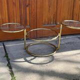 1970s swivel coffee table in gilded brass and glass, Milo Baughman style, vintage design.