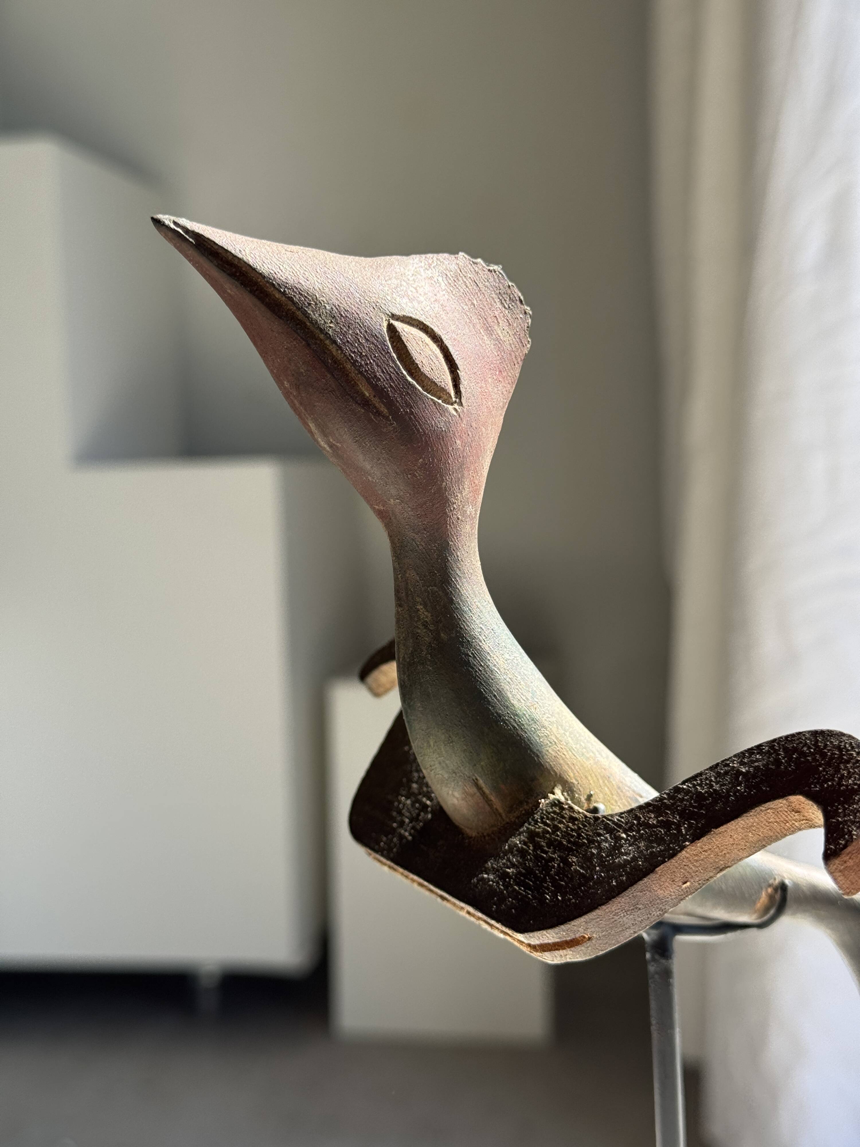 Traditional Indonesian decorative wooden bird on a base, crest model.