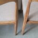 Pair of Scandinavian teak chairs sitting beige gray fabric