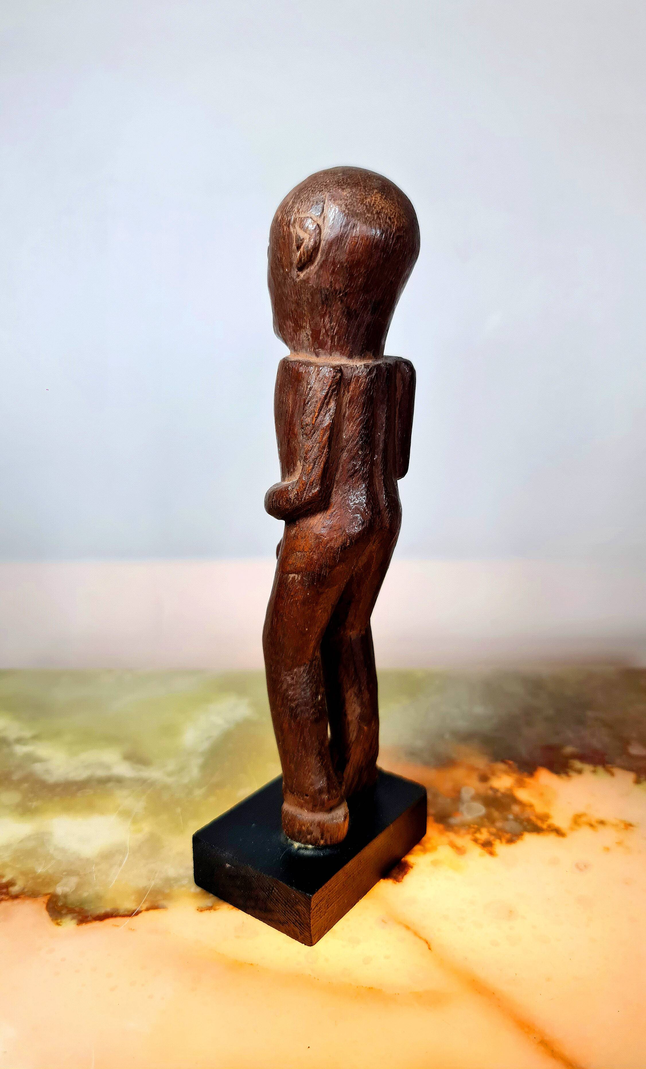 Old Fon statuette on a base, Benin