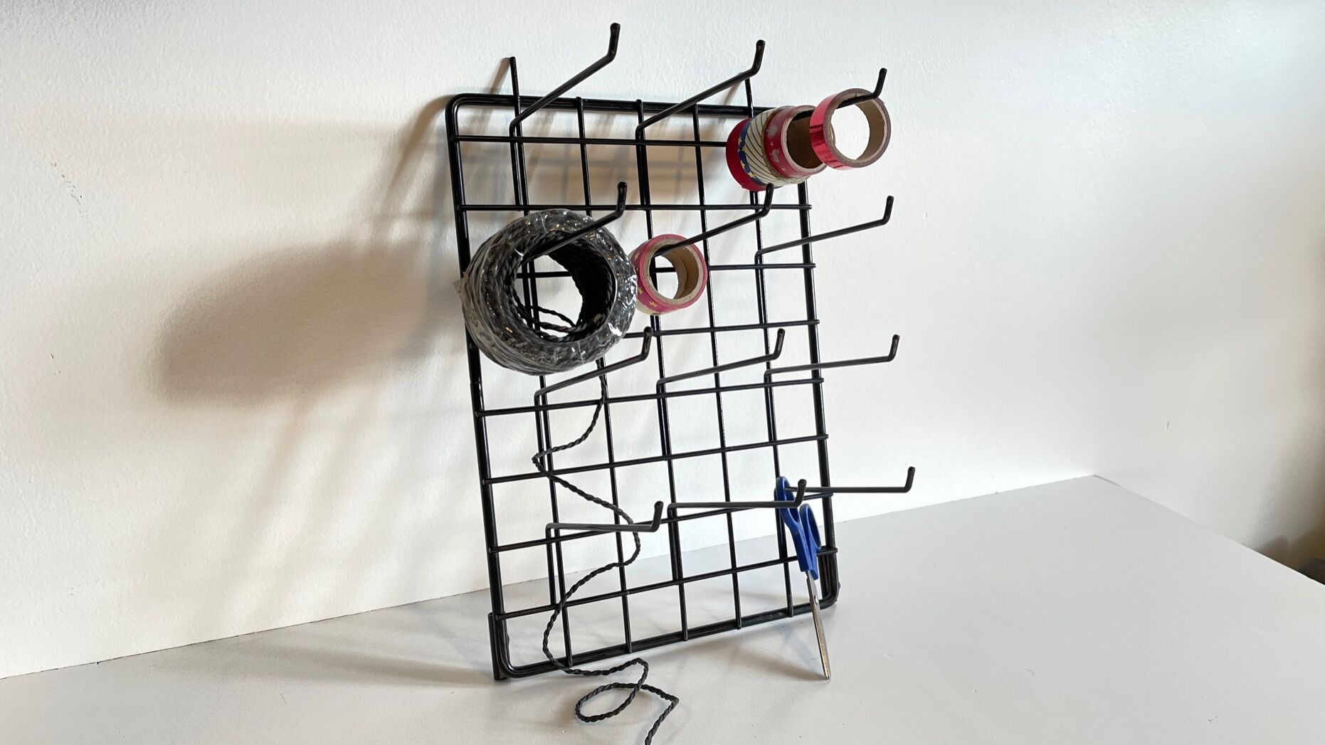 Vintage black metal wall loom display