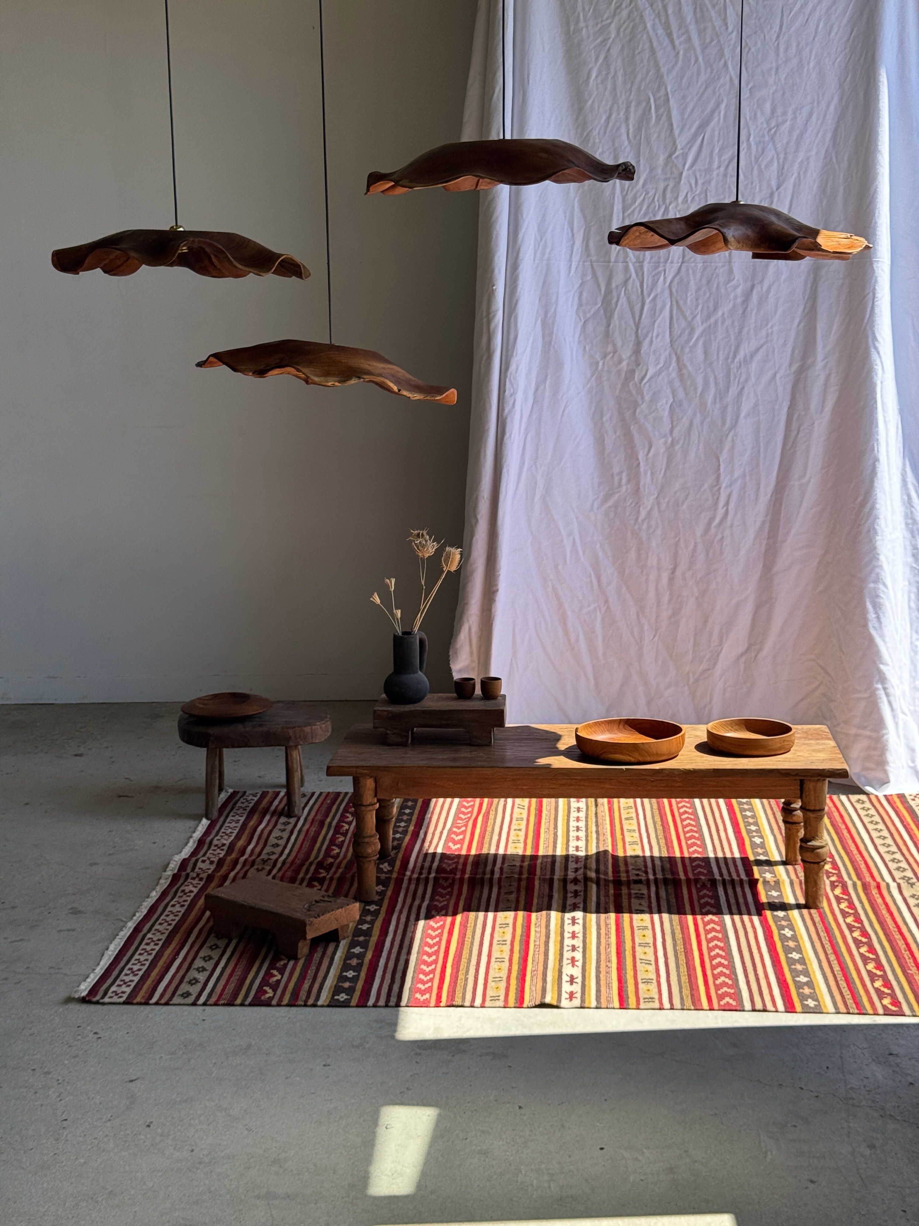 Large Indian rug with red, yellow, and white stripes and geometric fringes.