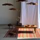 Large Indian rug with red, yellow, and white stripes and geometric fringes.