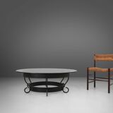 Rustic round coffee table with wrought iron base and glass top, France, 1930s
