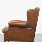 Cognac-colored sheepskin wing chair in English style