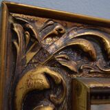 wall mirror in a decorative wooden frame.