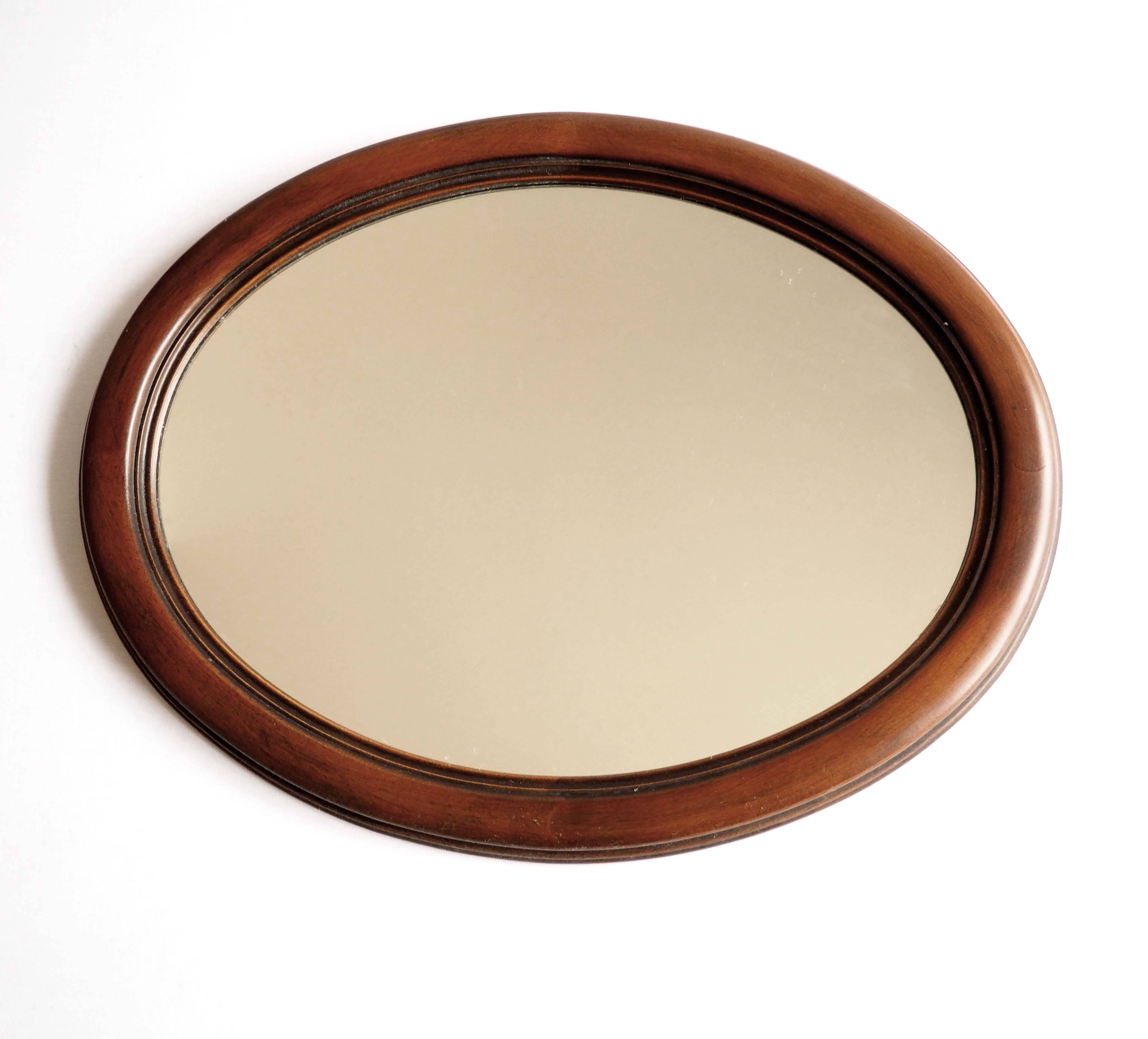 Oval mirror with wooden frame