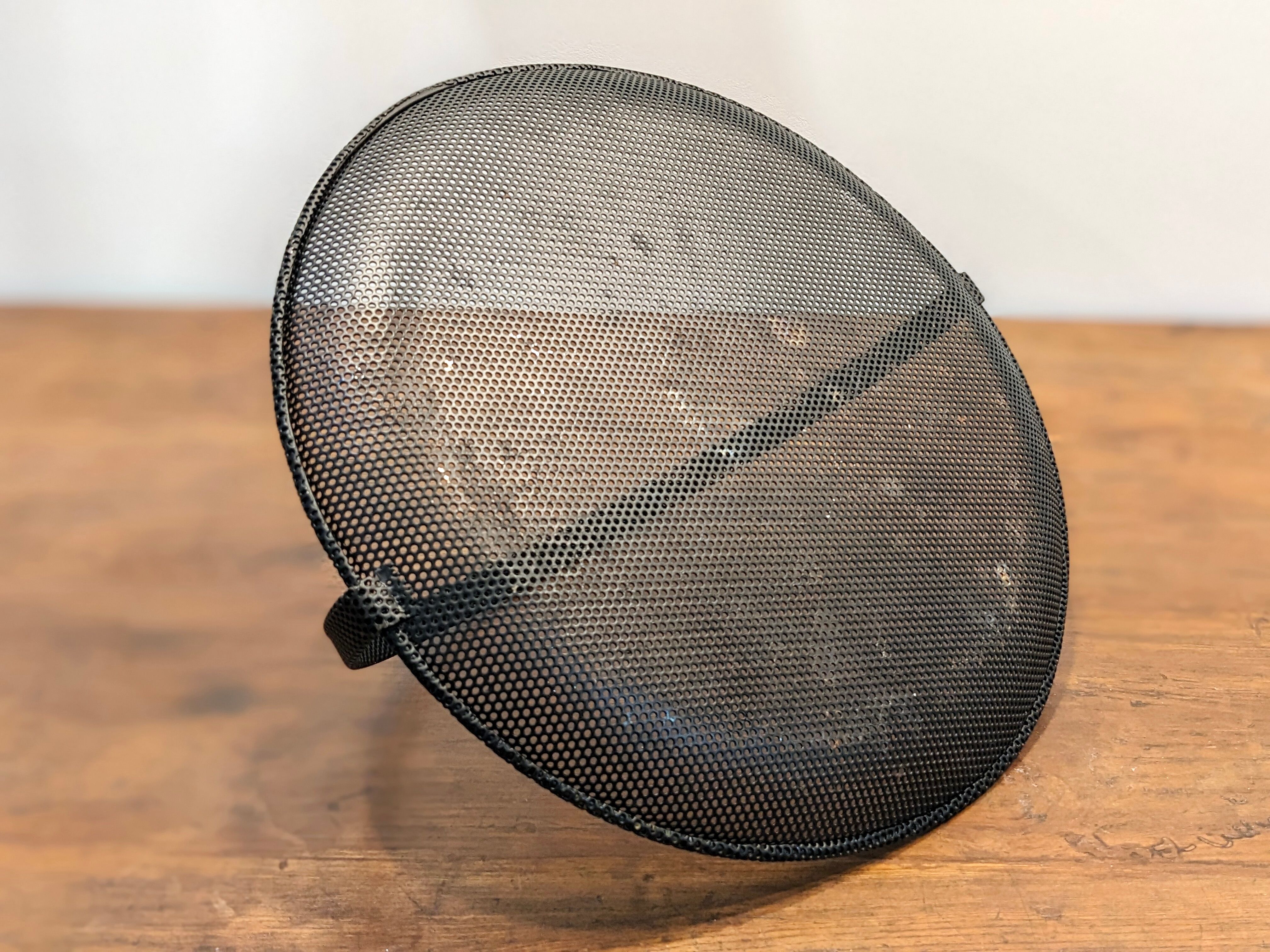 Black metal basket by Mathieu Mategot