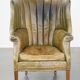 Green antique barrel back wingback chair on wheels