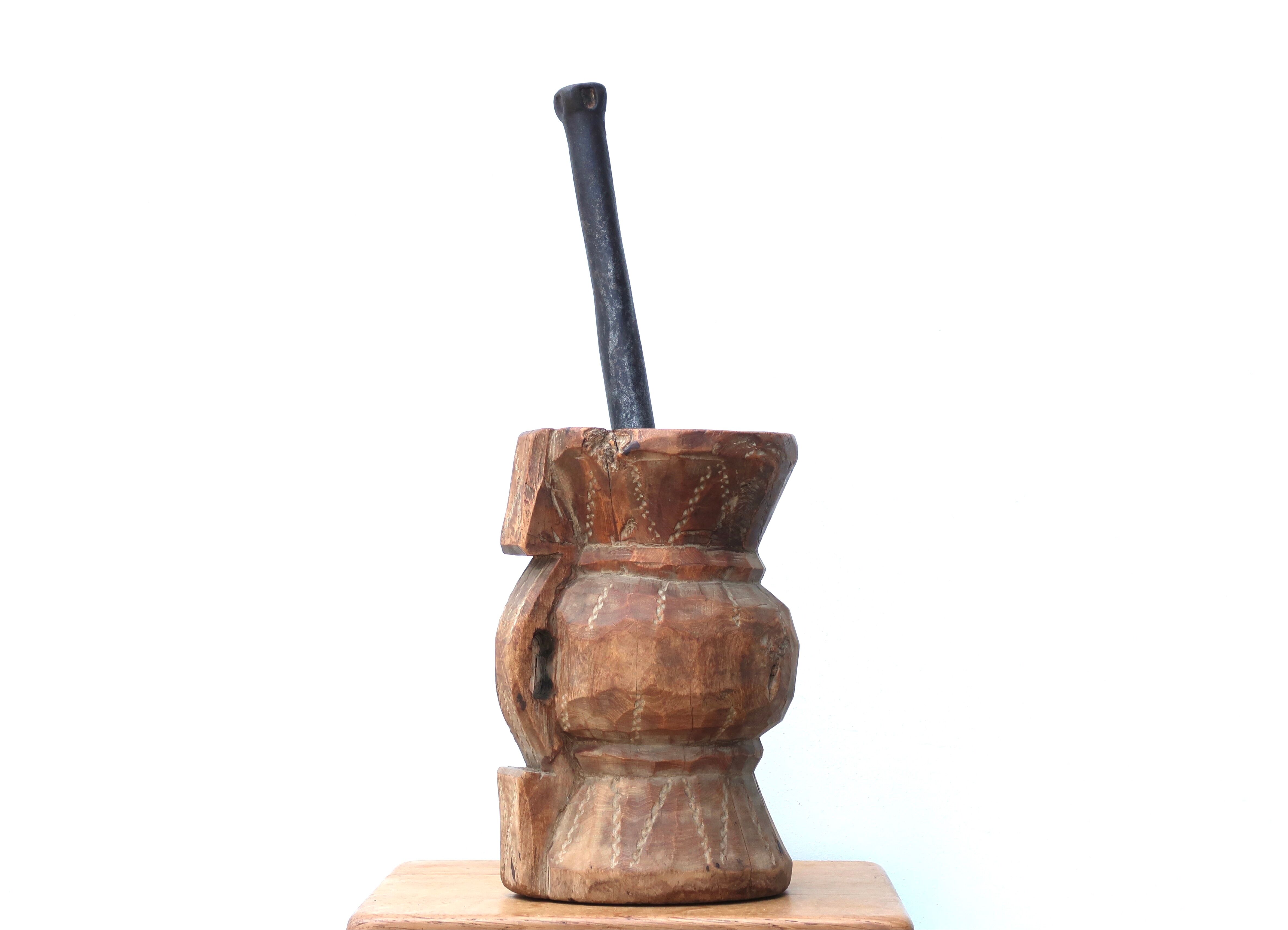 African mortar in carved wood, cast iron pestle, 70s