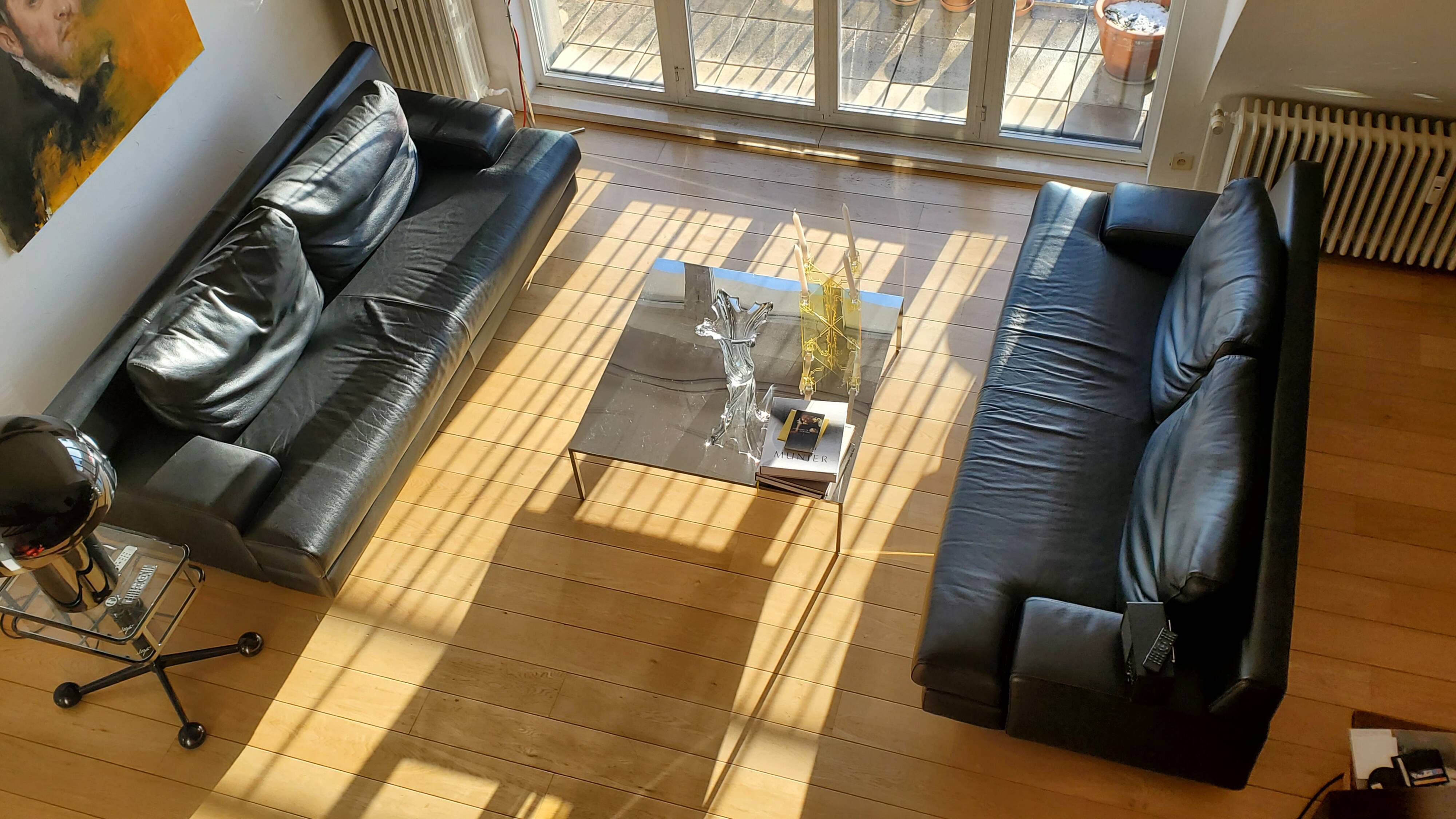 Black leather three-seater sofa