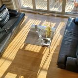 Black leather three-seater sofa