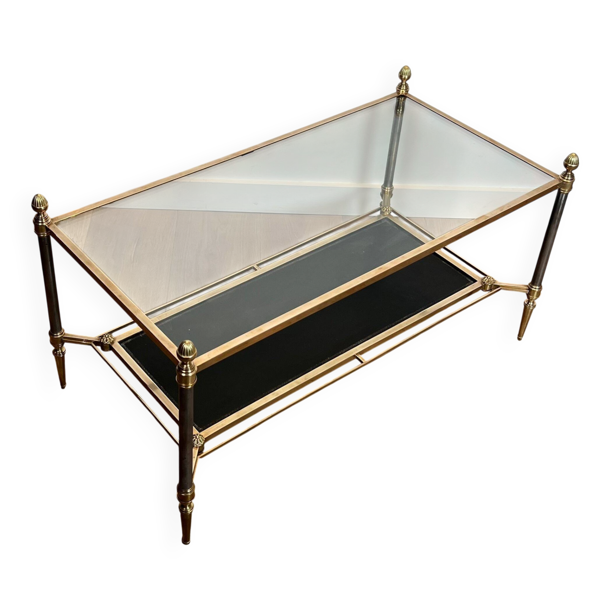 Brass coffee table with a black leather top and golden edges from Maison Jansen.