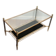 Brass coffee table with a black leather top and golden edges from Maison Jansen.