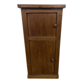 Old small storage unit with sliding and hinged doors.