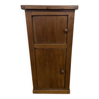 Old small storage unit with sliding and hinged doors.