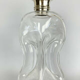 Blown glass carafe with silver frame and cap