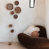 Mini round cushion with ochre wool pompoms