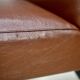 Low chair, circa 1950. Brown imitation leather.