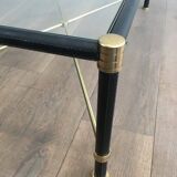 Brass coffee table upholstered in black leather. In the style of Jacques Adnet.