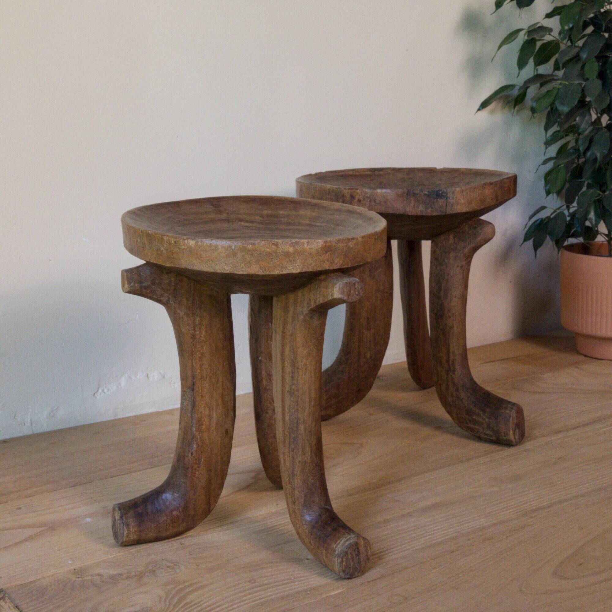 Pair of ancient Ethiopian tripod stools made of monoxyle wood.