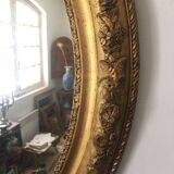 Miroir ovoïde dorure a la feuille d'or, debut xxème