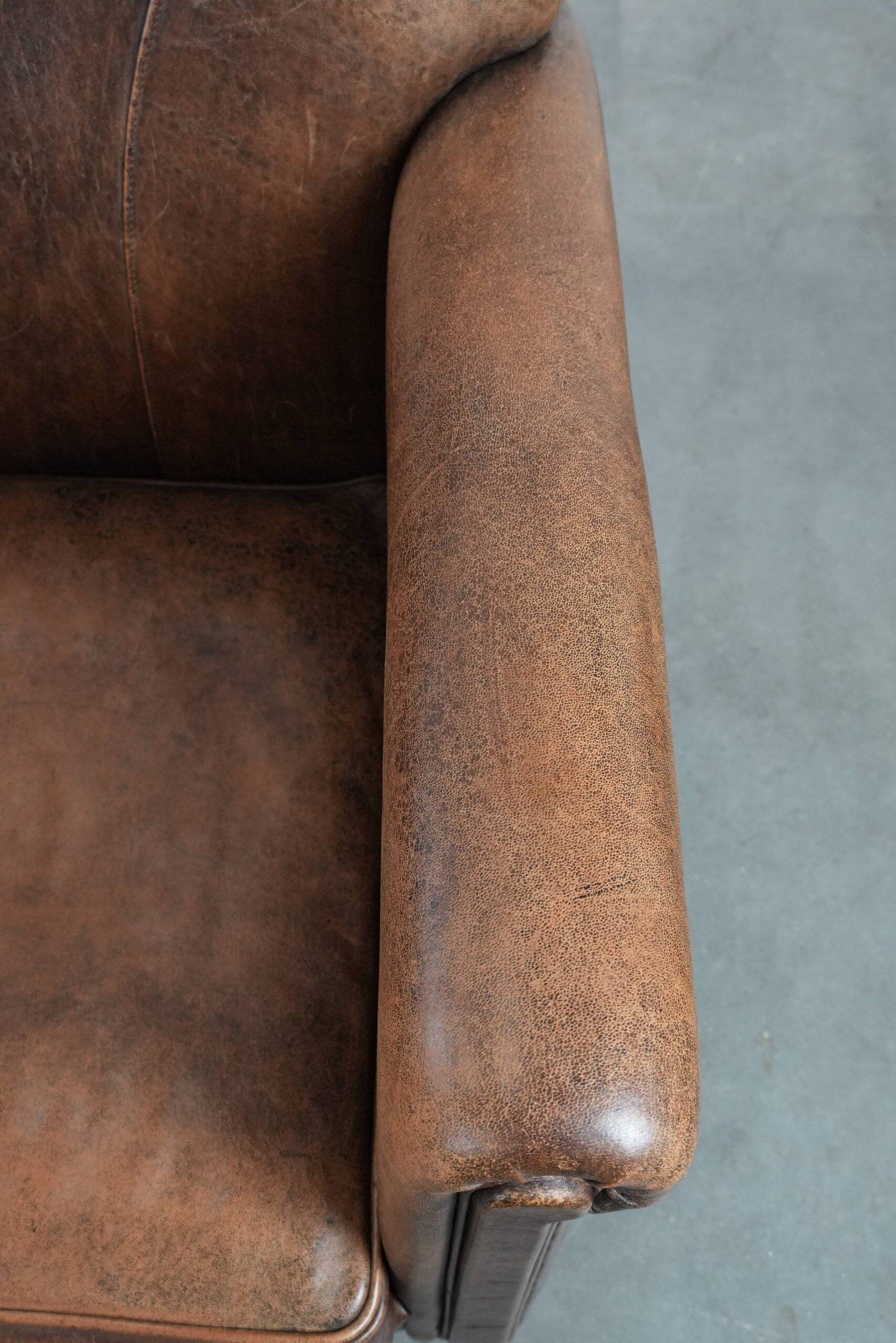 Set of 2 vintage sheepskin armchairs with a characterful appearance