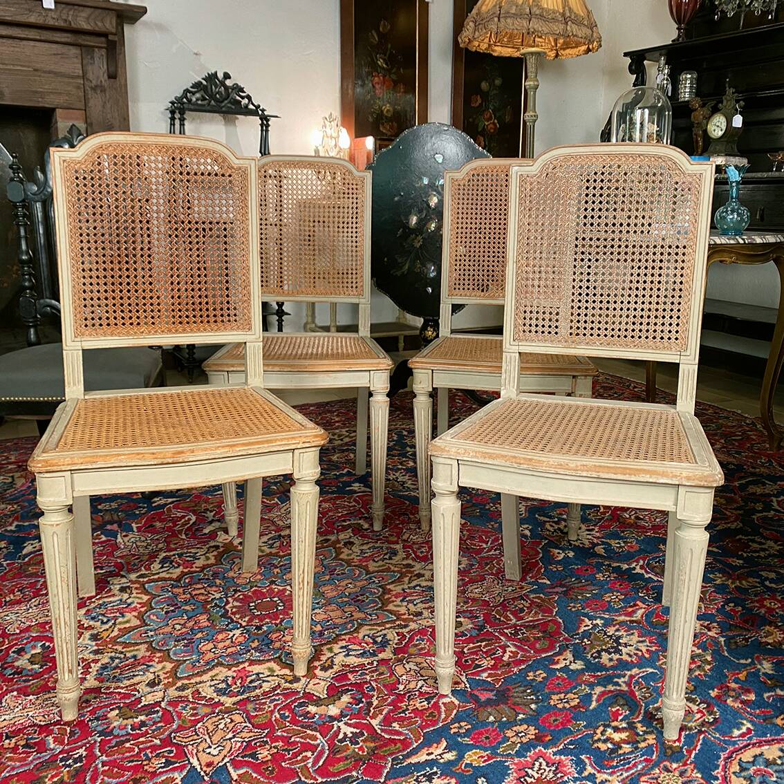 Set of four grey lacquered wooden chairs in the Louis XVI style, late 19th century.