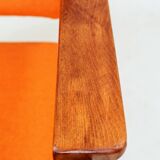 Vintage armchair in papaya orange wool from the 1960s.